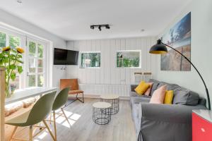 a living room with a couch and a table at The Forester Schoorl in Schoorl