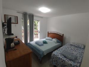 Postel nebo postele na pokoji v ubytování Residencial 101 Ilha Grande