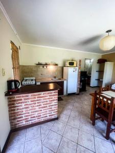 a kitchen with a brick counter and a refrigerator at don isidro cabaña in La Paz