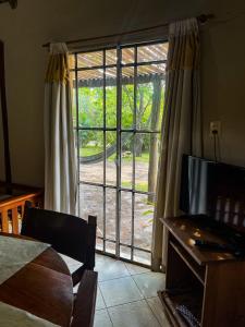 a room with a large window with a view of a yard at don isidro cabaña in La Paz