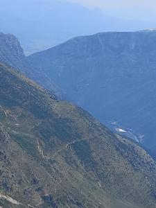 an aerial view of a mountain with a body of water at VILA CANI in Tepelenë