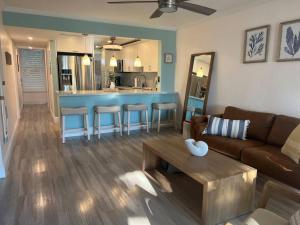 a living room with a couch and a table at Serenity at Moon Bay! in Key Largo