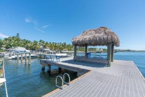 a dock with a bench and a hut on the water at Serenity at Moon Bay! in Key Largo