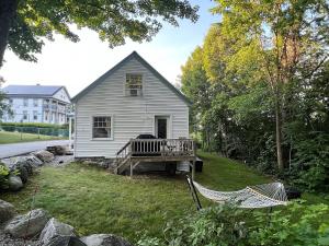 a white house with a hammock in the yard at Rustic Retreat 3 Min Walk From Main St Plymouth in Plymouth