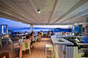 a restaurant with a view of the ocean at Agios Prokopios Hotel in Agios Prokopios
