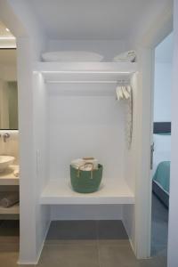 a bathroom with a shelf with a bowl on it at Alexandros Apartments in Naousa