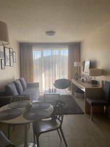 a living room with a couch and a table and chairs at Apartament Czarna Góra in Sienna