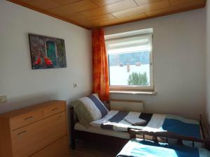 a small bedroom with a bed and a window at Four Season Apartment Irene in Eisenerz