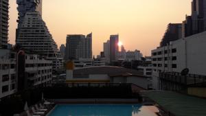 a view of a city at sunset from a building at Panoramic City View Room at Silom in Bangkok