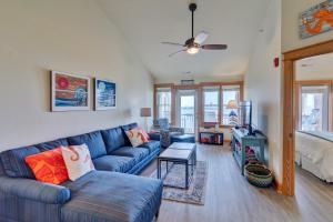 a living room with a blue couch and a bed at C309 - Sounds Good 309 in Nags Head