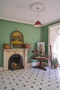 a living room with a fireplace and a table at Delphi Lodge in Leenaun