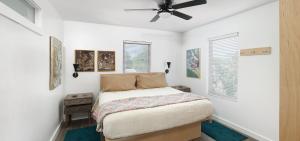 a bedroom with a bed and a ceiling fan at Folly Vacation Fantastic Vibe! Incredible Apt D in Folly Beach