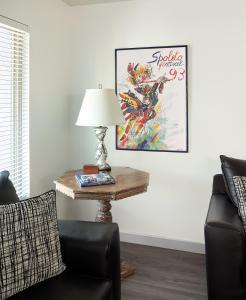 a living room with a table with a lamp and a chair at Folly Vacation Fantastic Vibe! Incredible Apt D in Folly Beach