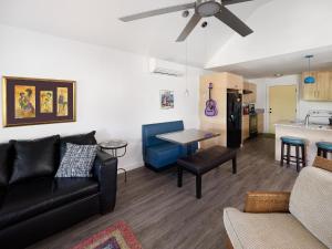 a living room with a couch and a table at Folly Vacation Fantastic Vibe! Incredible Apt D in Folly Beach