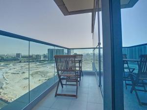 a balcony with chairs and a view of the city at Key View - Orchid Residence in Dubai