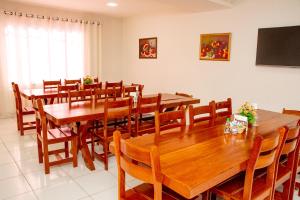 a large dining room with wooden tables and chairs at Letiva Hotel Centro in Sobral