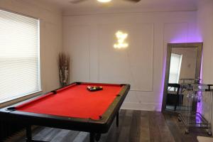 a room with a red pool table in it at Comfy! Cozy! Spacious! in Eastpointe