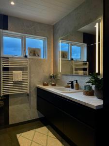 a bathroom with a sink and a mirror at Fjallagil in Varmahlid