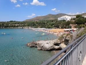 a beach with a bunch of people in the water at Residence La Playa in Marina di Camerota