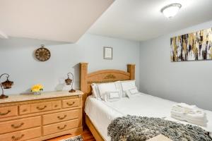 a bedroom with a bed and a wooden dresser at Cozy Albany Vacation Rental about 5 Mi to Downtown! in Albany