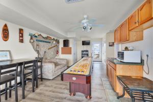 a kitchen and living room with a ping pong table at 7030 - Waves Against the Machine by Resort Realty in Rodanthe
