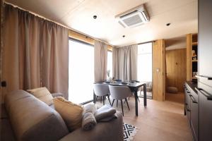 a living room with a couch and a table at Jazine beach villas in Tisno