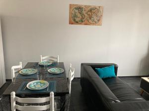 a living room with a table and a couch at Maison tout confort in Corbie +19 photos