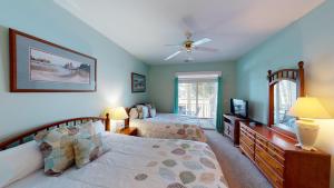 a bedroom with two beds and a ceiling fan at Beautiful 2BR 2BA Lakeside Villa with Lake Views in Pawleys Island