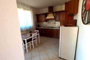 a kitchen with a table and a white refrigerator at Hygge Holiday House in Luino +7 photos