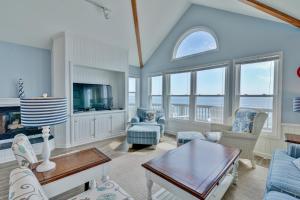 a living room filled with furniture and a tv at 7048 - Tide Song by Resort Realty in Rodanthe