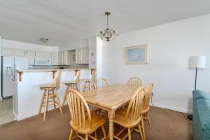 a kitchen and dining room with a wooden table and chairs at 7051 - Hatteras High 5A by Resort Realty in Rodanthe