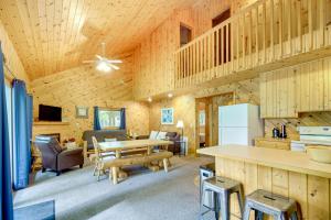 a kitchen and living room with a table in a cabin at Detroit Lakes Cabin Rental on Long Lake! in Detroit Lakes
