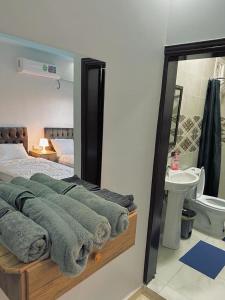a bedroom with a bed and a sink and a mirror at Leen Guest House in Wadi Musa