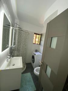 a bathroom with a sink and a toilet and a shower at VD Apartament 2 in Constanţa