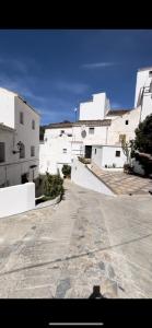 a group of white buildings and a street at Tiny Spanish House in Casares
