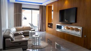 a living room with a couch and a tv at Villa HAW Marrakech in Marrakesh