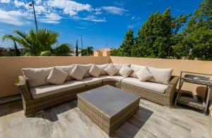 a wicker couch sitting on a patio at Villa HAW Marrakech in Marrakech