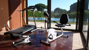 a gym with two exercise bikes in front of a window at Tenuta Bartoli Maison de Charme in Mazzarino
