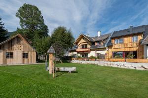 a large wooden house with a yard with a yard at Heimathaus Dengg - Sommerfrische im Salzburger Land in Mauterndorf