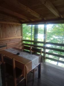 a dining room with a table and chairs in a cabin at Drinski San in Bajina Bašta +25 photos