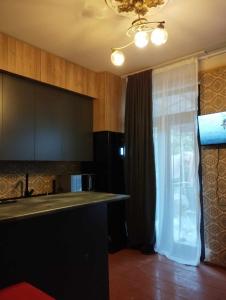 a kitchen with a window and a sink and a counter at GuestHouse Oni-Li in Oni