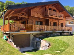 a large wooden house with a large garage at Chalet Maillet Mieussy in Mieussy