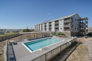 a swimming pool on a deck next to a building at 7055 - Hatteras High 8C by Resort Realty in Rodanthe