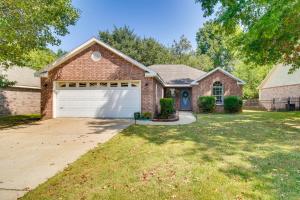 a brick house with a garage at Charming Arkansas Retreat with Deck, Near Downtown! in Fayetteville