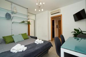 a bedroom with a bed and a table with chairs at [Design House] A/C WIFI 20 minutes from DUOMO in Milan