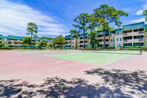 a tennis court with two tennis rackets at Spa On Port Royal Sound 2217 in Hilton Head Island