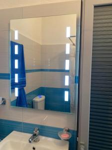 a bathroom with a sink and a mirror at Rooms for rent Gezim Ismailaj 