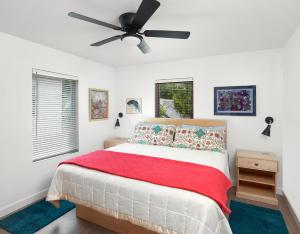 a bedroom with a bed and a ceiling fan at Folly Vacation Great Location, Super Cute & Spacious Apt B in Folly Beach