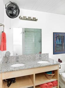 a bathroom with two sinks and a mirror at Folly Vacation Great Location, Super Cute & Spacious Apt B in Folly Beach