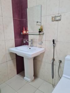 a bathroom with a sink and a shower at Mountain Balcony House in Nizwa +33 photos